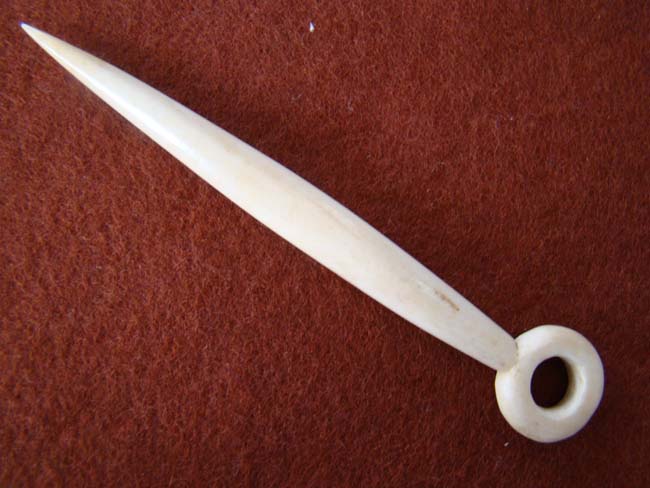 A 19th century sailor carved whalebone bodkin with open ring end